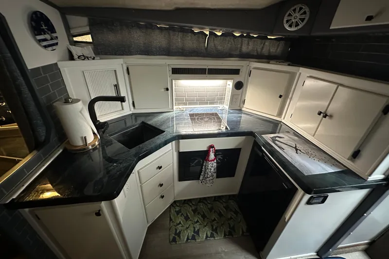 Slide: The Image of 1986 Sea Ray 340 Express Cruiser helm with steering wheel and gauges. - 12