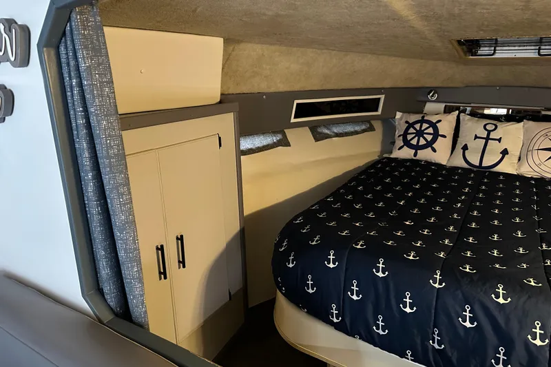 Slide: The Image of Interior of 1986 Sea Ray 340 Express Cruiser with plush seating and nautical-themed decor. - 14