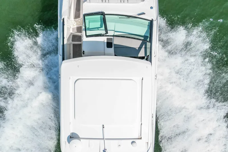 Slide: The Image of 2022 Sea Ray Sundancer 320 Outboard cruising on water, aerial view. - 14