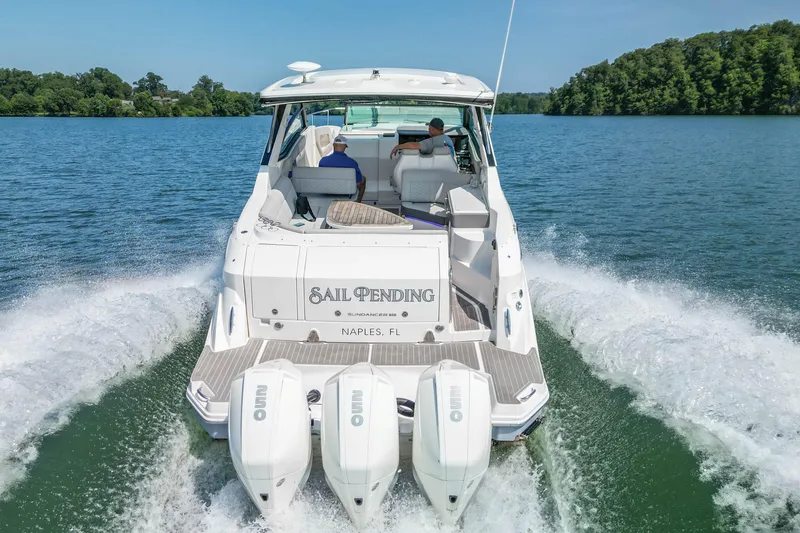 Slide: The Image of 2022 Sea Ray Sundancer 320 Outboard cruising on a lake, rear view with triple engines. - 15