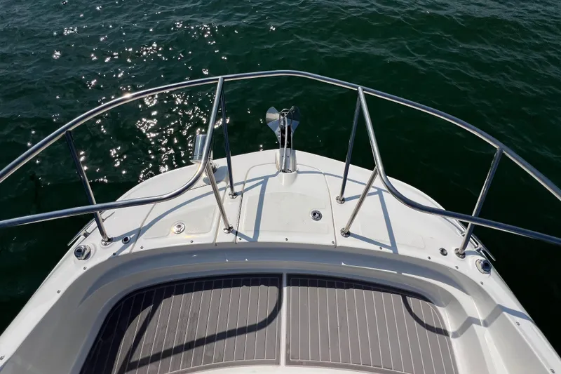 Slide: The Image of Bow of 2022 Sea Ray Sundancer 320 Outboard on water. - 25