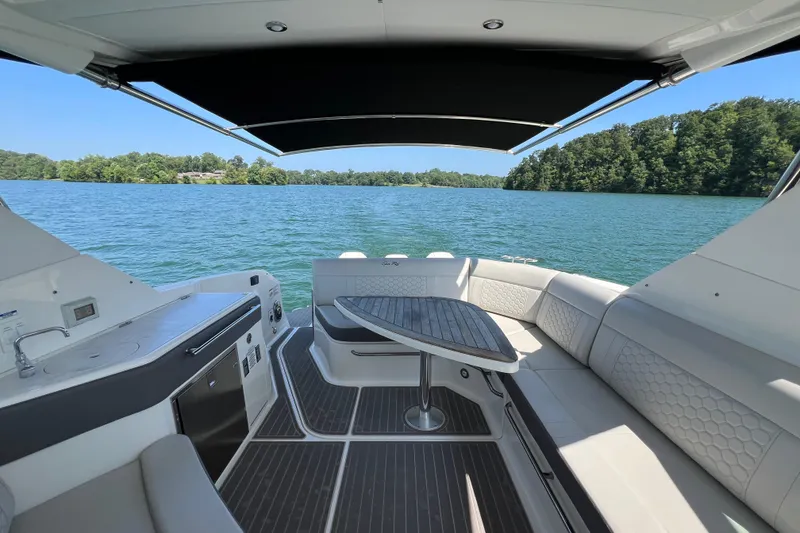 Slide: The Image of Luxurious 2022 Sea Ray Sundancer 320 Outboard interior with lake view and elegant seating. - 30