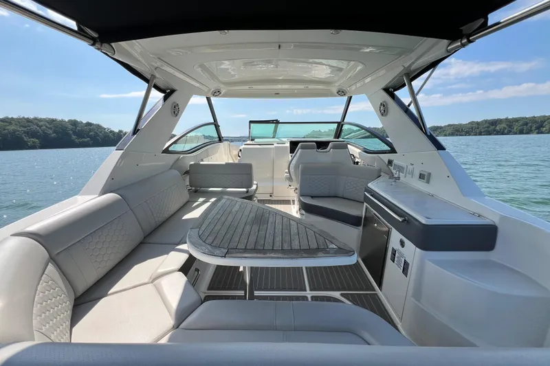 Slide: The Image of 2022 Sea Ray Sundancer 320 Outboard interior with luxurious seating and scenic lake view. - 32