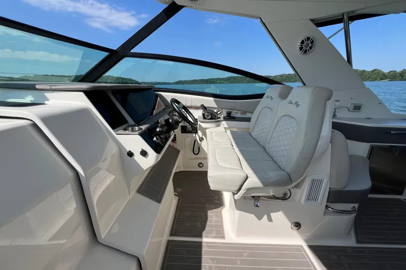 Slide: The Image of 2022 Sea Ray Sundancer 320 Outboard cockpit with luxurious seating and modern controls. - 38