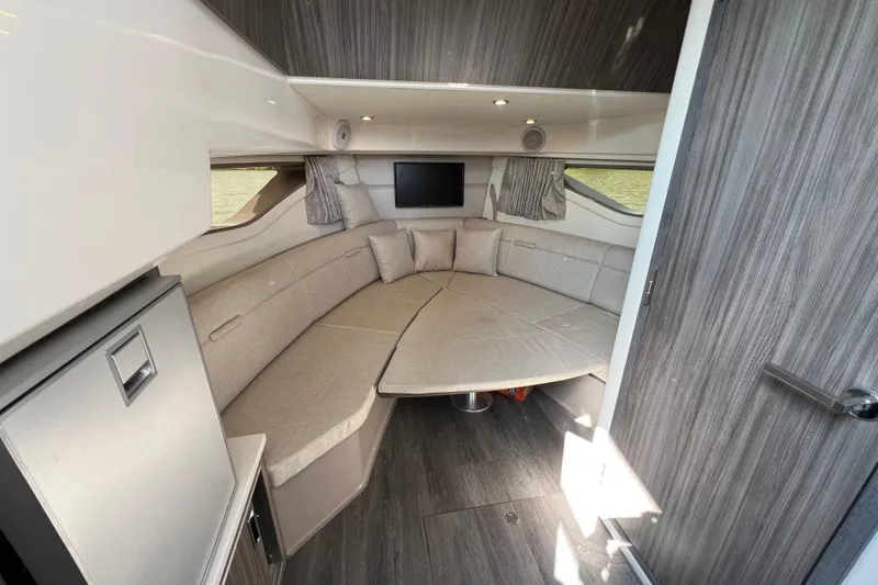 Slide: The Image of 2022 Sea Ray Sundancer 320 Outboard cabin interior with seating and modern decor. - 41