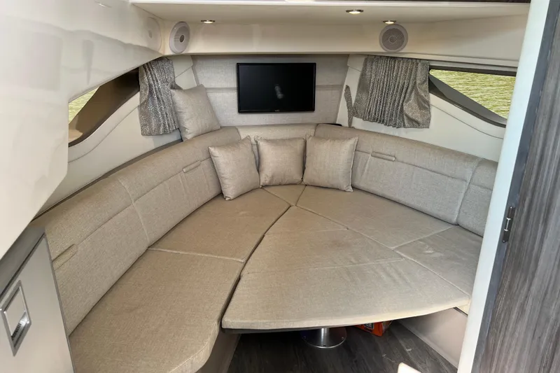 Slide: The Image of Interior of 2022 Sea Ray Sundancer 320 Outboard with cozy seating and TV. - 42