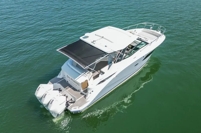 Slide: The Image of 2022 Sea Ray Sundancer 320 Outboard cruising on open water, aerial view. - 8