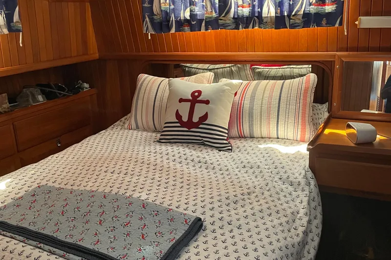 Slide: The Image of Cozy cabin interior of 1986 Monk 36 Trawler with nautical-themed bedding and decor. - 13