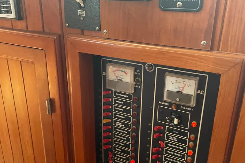 Slide: The Image of Electrical panel on a 1986 Monk 36 Trawler, featuring gauges and switches. - 16