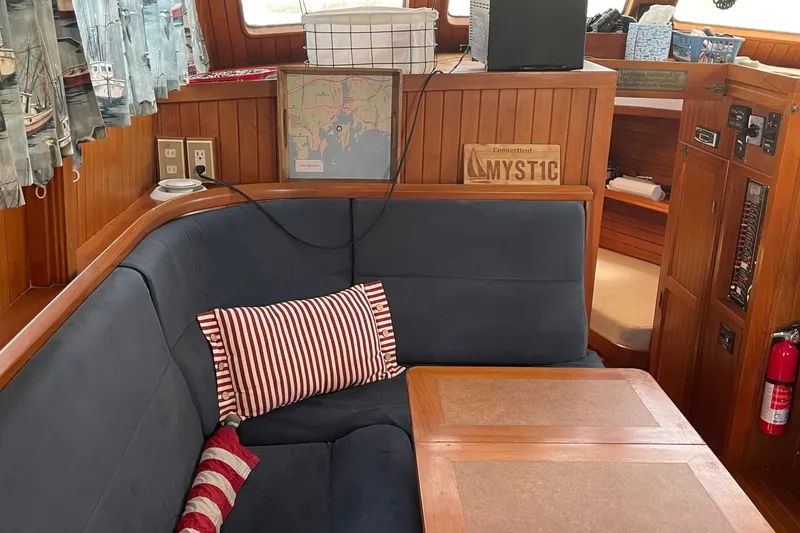 Slide: The Image of Cozy interior of 1986 Monk 36 Trawler with nautical decor and seating area. - 7