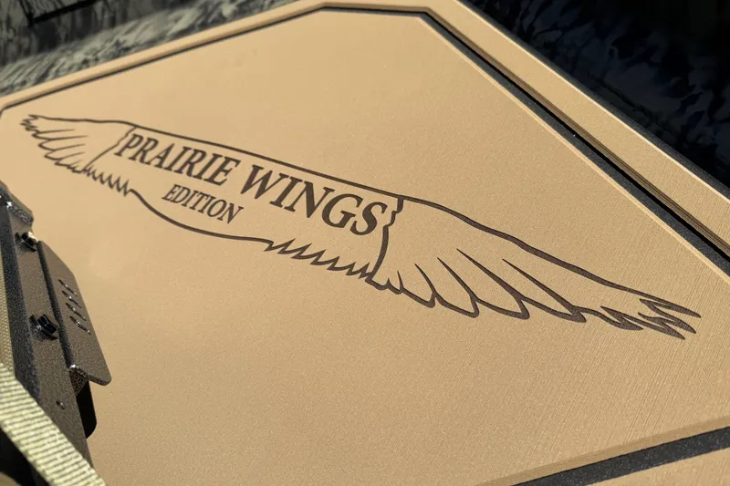 Slide: The Image of 2026 Tracker Grizzly 1650 T Prairie Wings Edition logo on tan surface. - 10