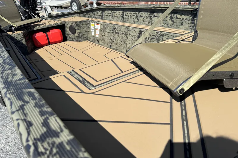 Slide: The Image of 2026 Tracker Grizzly 1650 T Prairie Wings Edition boat interior with camouflage design and seating. - 11