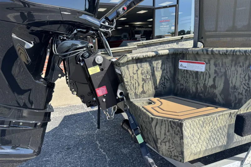 Slide: The Image of 2026 Tracker Grizzly 1650 T Prairie Wings Edition boat with camouflage design and motor detail. - 4