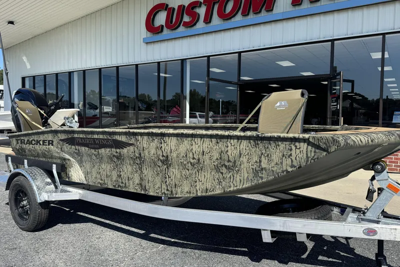 Slide: The Image of 2026 Tracker Grizzly 1650 T Prairie Wings Edition boat on trailer outside dealership. - 5