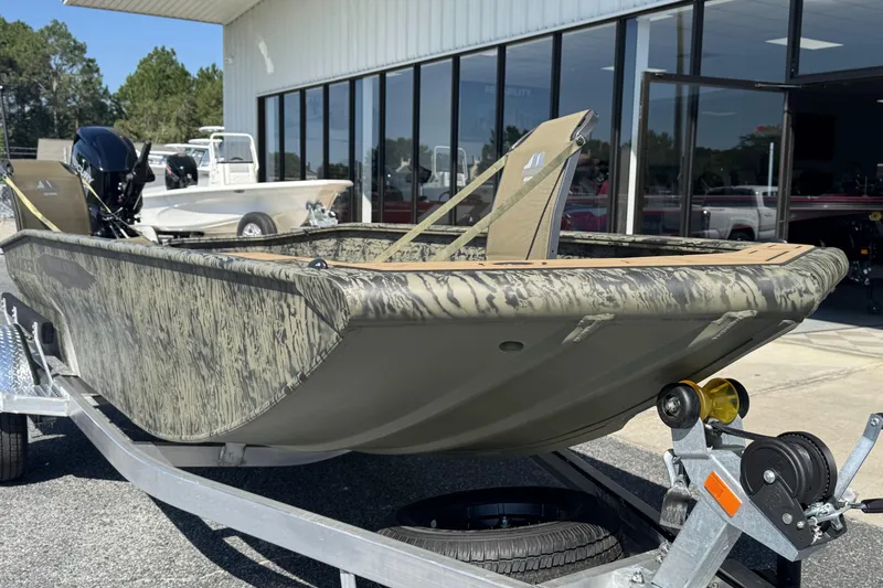 Slide: The Image of 2026 Tracker Grizzly 1650 T Prairie Wings Edition boat on trailer, camo design, outdoor showroom. - 6