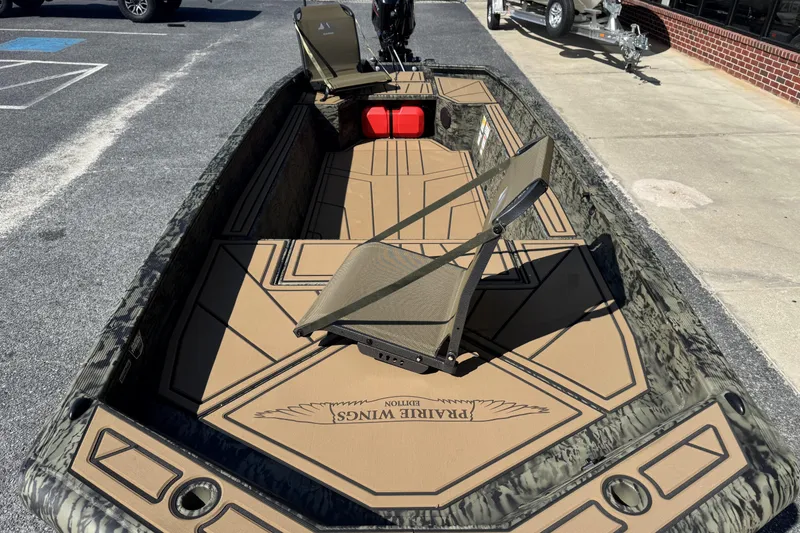 Slide: The Image of 2026 Tracker Grizzly 1650 T Prairie Wings Edition boat with camouflage design and seating. - 7