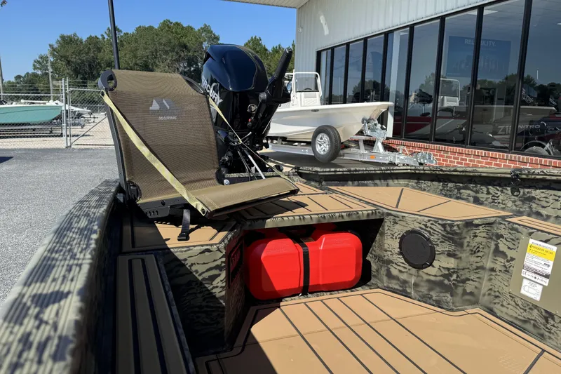 Slide: The Image of 2026 Tracker Grizzly 1650 T Prairie Wings Edition boat with camo design and red fuel tank. - 9