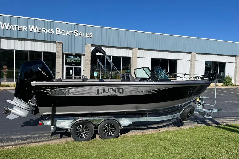 Slide: The Image of 2026 Lund 2275 Baron boat on trailer outside Water Werks Boat Sales. - 0