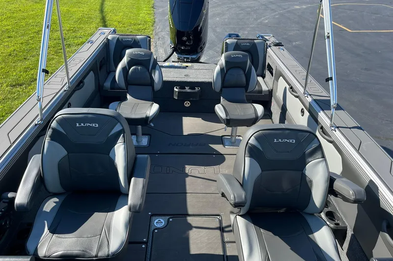 Slide: The Image of 2026 Lund 2275 Baron boat interior with four cushioned seats and sleek design. - 10