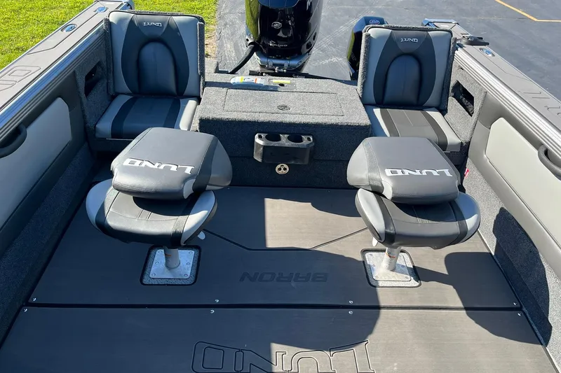 Slide: The Image of 2026 Lund 2275 Baron boat interior with seating and storage compartments. - 12