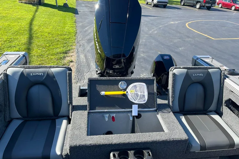 Slide: The Image of 2026 Lund 2275 Baron boat interior with seating and storage compartments. - 14