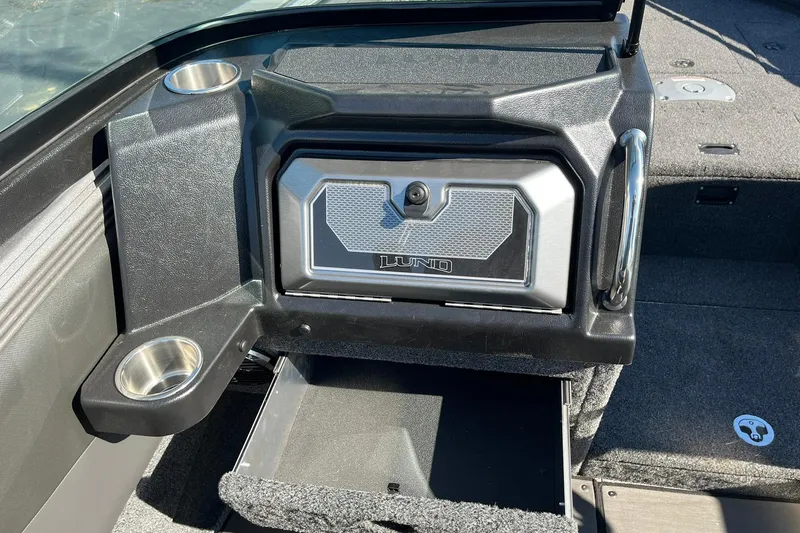 Slide: The Image of 2026 Lund 2275 Baron boat interior with storage compartment and cup holders. - 22