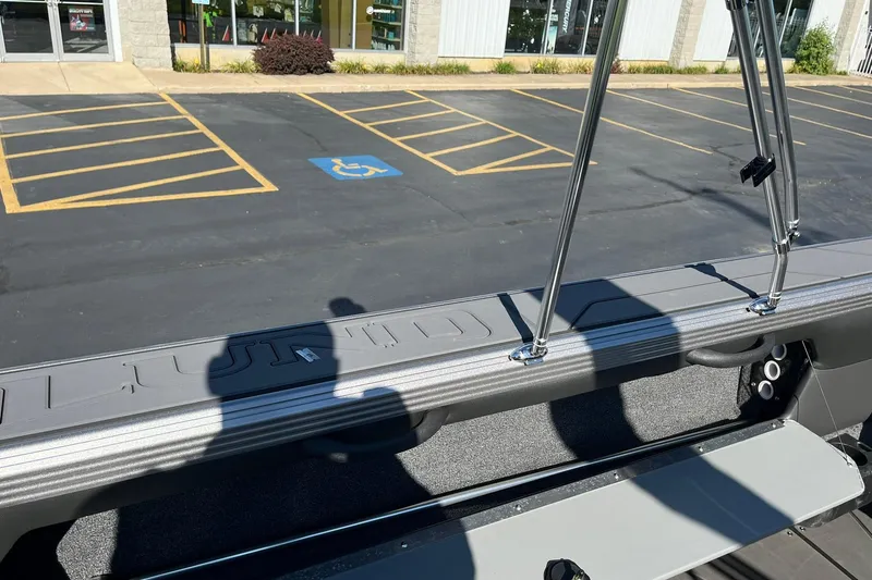 Slide: The Image of 2026 Lund 2275 Baron boat interior with parking lot view in background. - 32