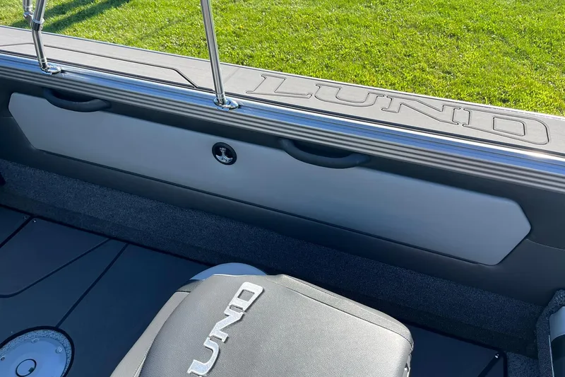 Slide: The Image of 2026 Lund 2275 Baron boat interior with logo, featuring sleek seating and storage. - 33