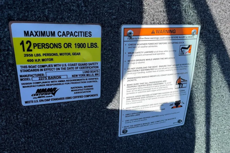Slide: The Image of Safety and capacity labels on 2026 Lund 2275 Baron boat, 12-person limit, 400 HP motor. - 39