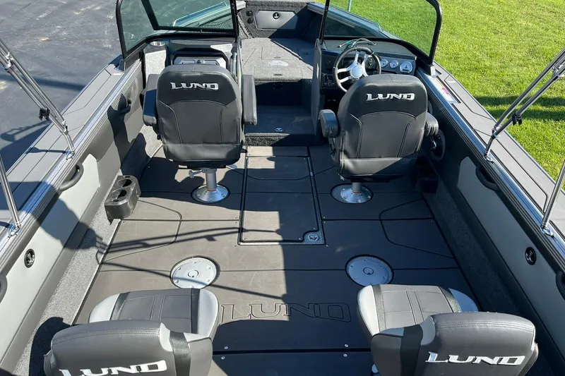 Slide: The Image of 2026 Lund 2275 Baron boat interior with four seats and steering console. - 8