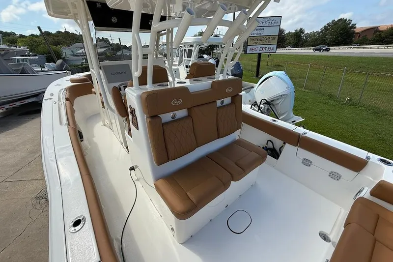 Slide: The Image of 2026 Key West 291 FS boat interior with tan seating and Garmin equipment. - 10