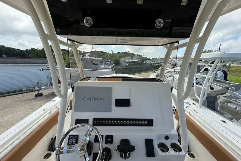 Slide: The Image of 2026 Key West 291 FS boat dashboard with Garmin navigation system, docked near water. - 17