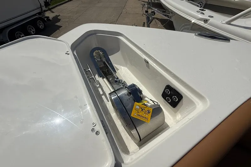 Slide: The Image of 2026 Key West 291 FS boat anchor compartment with warning label and controls. - 28