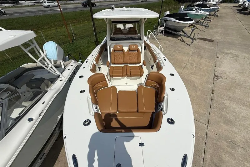 Slide: The Image of 2026 Key West 291 FS boat with tan seating, docked outdoors. - 29
