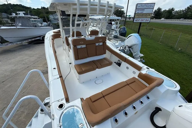 Slide: The Image of 2026 Key West 291 FS boat with tan seating, docked outdoors. - 6