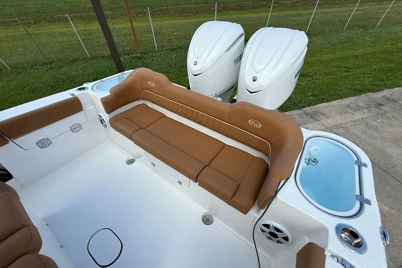 Slide: The Image of 2026 Key West 291 FS boat interior with tan seating and dual Yamaha engines. - 7