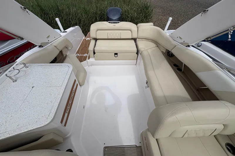 Slide: The Image of 2018 Regal 26 OBX boat interior with beige seating, steering wheel, and dashboard. - 10