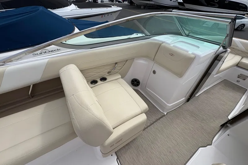 Slide: The Image of 2018 Regal 26 OBX boat dashboard with steering wheel, gauges, and navigation system. - 12