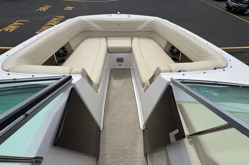 Slide: The Image of 2018 Regal 26 OBX boat interior with beige seating and cup holders. - 14