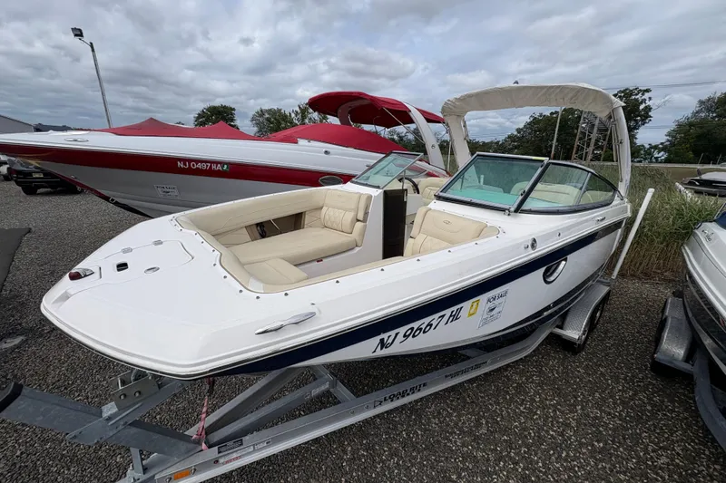 Slide: The Image of 2018 Regal 26 OBX boat with Yamaha 300 outboard motor, docked on gravel. - 3