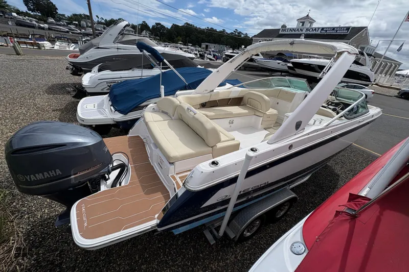 Slide: The Image of 2018 Regal 26 OBX boat with Yamaha outboard motor on trailer, parked outdoors. - 5