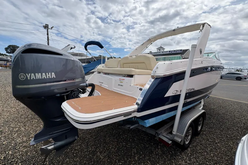 Slide: The Image of 2018 Regal 26 OBX boat with Yamaha outboard motor on a trailer. - 6