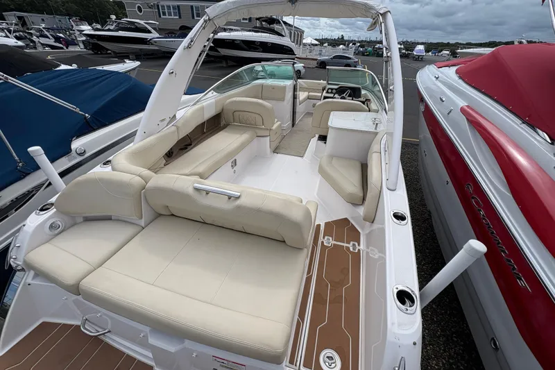Slide: The Image of 2018 Regal 26 OBX boat interior with beige seating and a small table. - 8