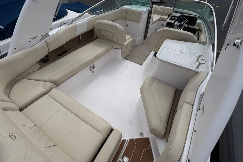 Slide: The Image of Interior of a 2018 Regal 26 OBX boat with beige seating and table. - 9