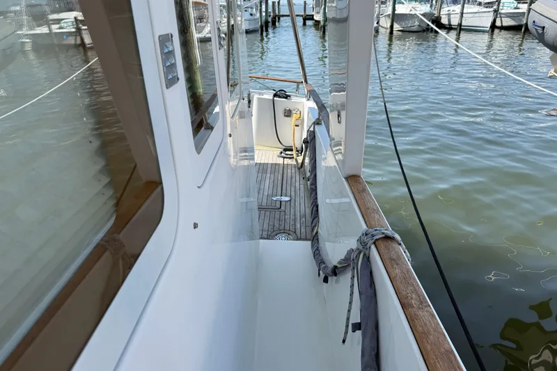 Slide: The Image of 2007 Beneteau Swift Trawler 42 docked, showcasing side deck and marina view. - 10