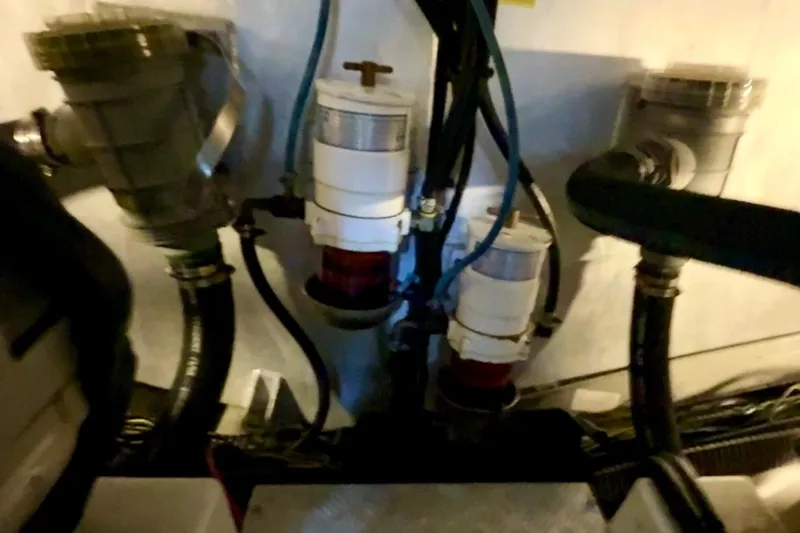 Slide: The Image of Engine room of a 2007 Beneteau Swift Trawler 42, showcasing mechanical components and hoses. - 100