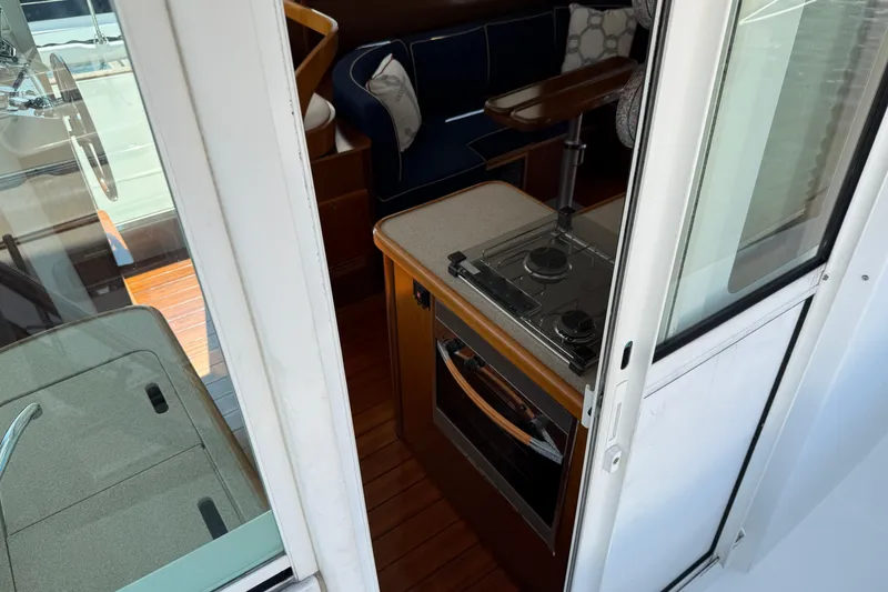 Slide: The Image of Interior view of 2007 Beneteau Swift Trawler 42, featuring compact kitchen area. - 11