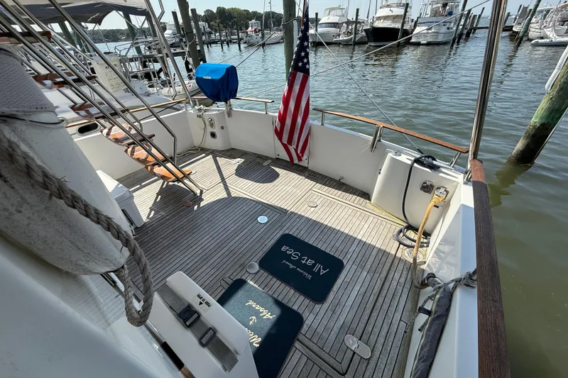 Slide: The Image of 2007 Beneteau Swift Trawler 42 deck with American flag, docked at marina. - 12