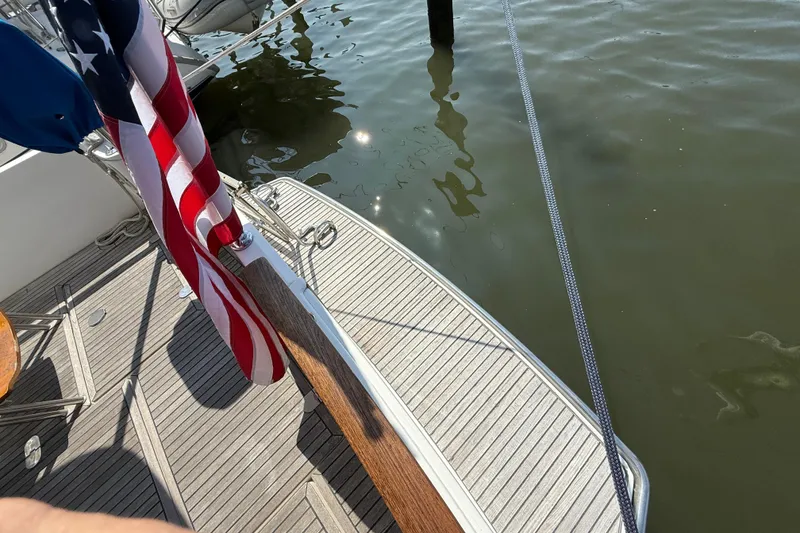 Slide: The Image of Beneteau Swift Trawler 42, 2007, deck view with American flag and water reflection. - 13