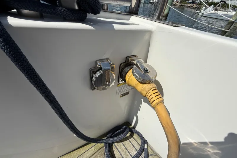 Slide: The Image of Power connection on a 2007 Beneteau Swift Trawler 42 boat, docked with visible ropes. - 15